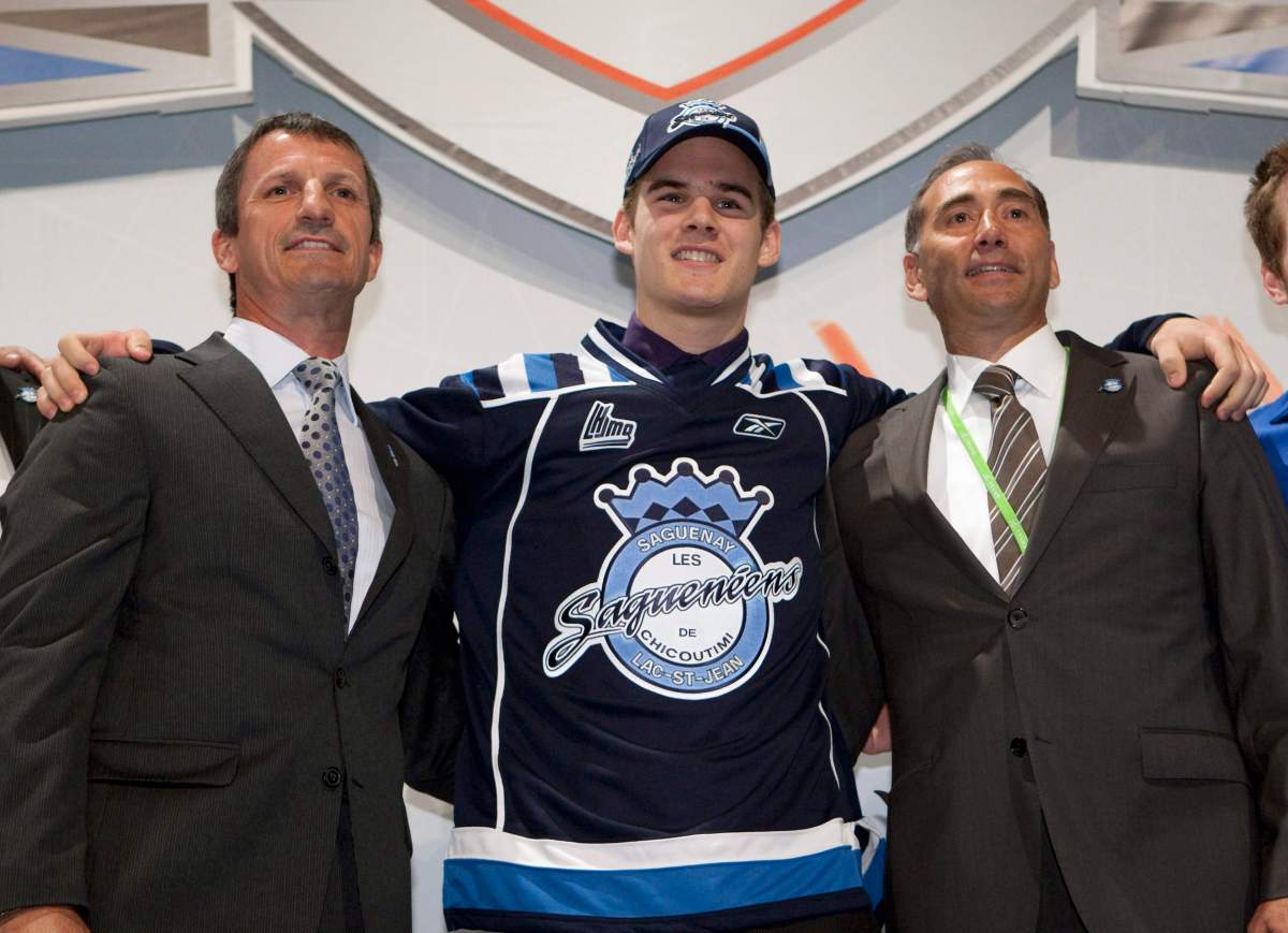Doninic Poulin of Quebec City is flanked by Sagueneens owner Guy Carbonneau, left, and team coach Richard Martel after he was picked as third overall pick of the 2010 QJMHL draft in 2010 in Drummondville, Que. Martel is now the Conservative candidate in a soon-to-be-called byelection in the riding of Chicoutimi–Le Fjord.