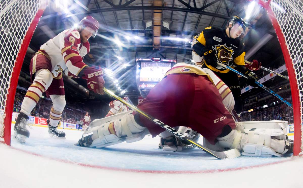 QMJHL Acadie-Bathurst Titan forward Samuel L'Italien (9) helps QMJHL Acadie-Bathurst Titan goalie Evan Fitzpatrick (31) stop a shot from OHL Hamilton Bulldogs forward Matthew Strome (18) during first period of Memorial Cup action in Regina on Tuesday, May, 22, 2018. THE CANADIAN PRESS/Jonathan Hayward.