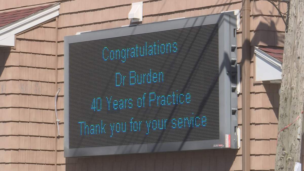 This sign, congratulating Dr. Burden on 40 years as a family physician is on the side of a local store in Elmsdale, N.S.