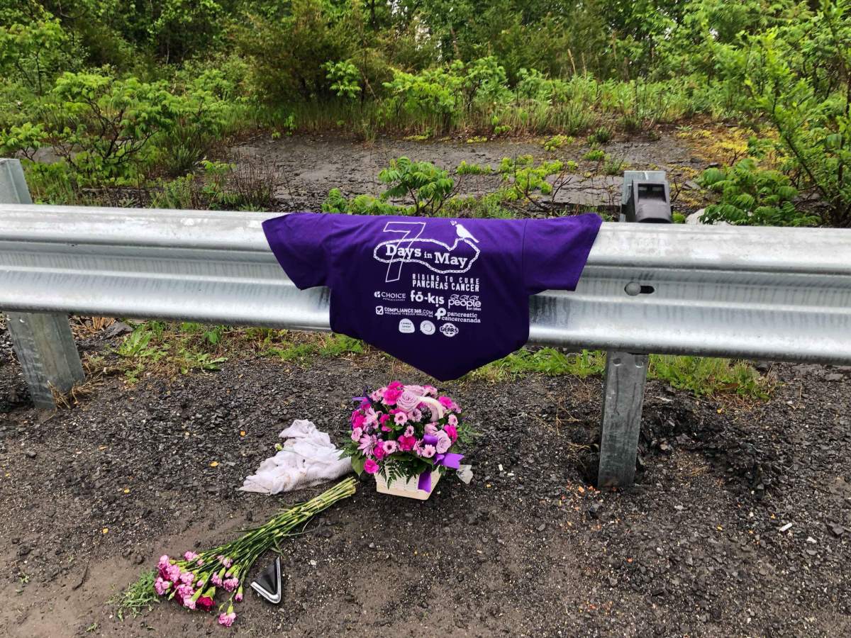 Someone laid out flowers and a cycling t-shirt at the spot where a cyclist was hit on Bath Road in Amherstview, and later died due to his injuries.