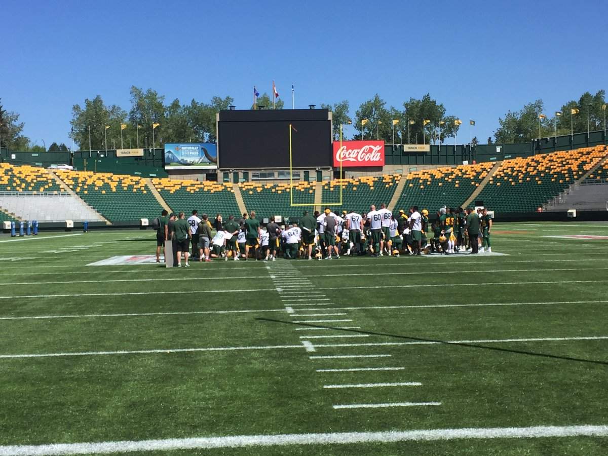 The Edmonton Eskimos huddle up after the opening day of training camp on The Brick Field at Commonwealth Stadium.