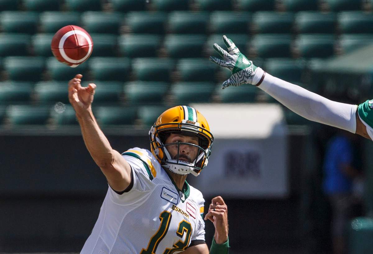 Edmonton Eskimos quarterback Mike Reilly (13) makes the pass against the Saskatchewan Roughriders during first half CFL pre-season action in Edmonton, Alta., on Sunday May 27, 2018.