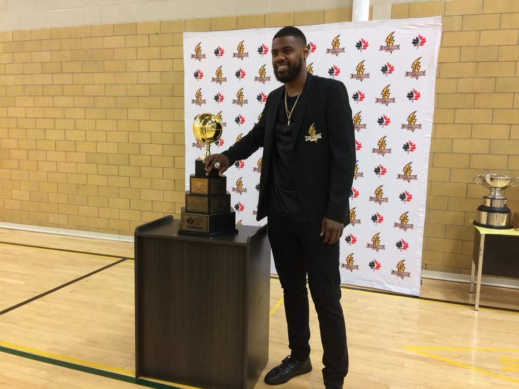 London Lightning shooting guard Kyle Johnson stands with the NBL Championship trophy.