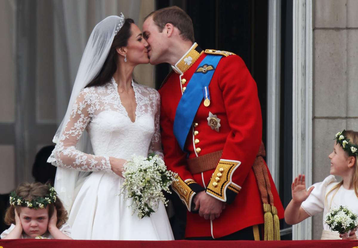 Their Royal Highnesses Prince William, Duke of Cambridge and Catherine, Duchess of Cambridge kiss on the balcony at Buckingham Palace on April 29, 2011 in London, England. spectacle and pageantry of the Royal Wedding. (Photo by Peter Macdiarmid/Getty Images)