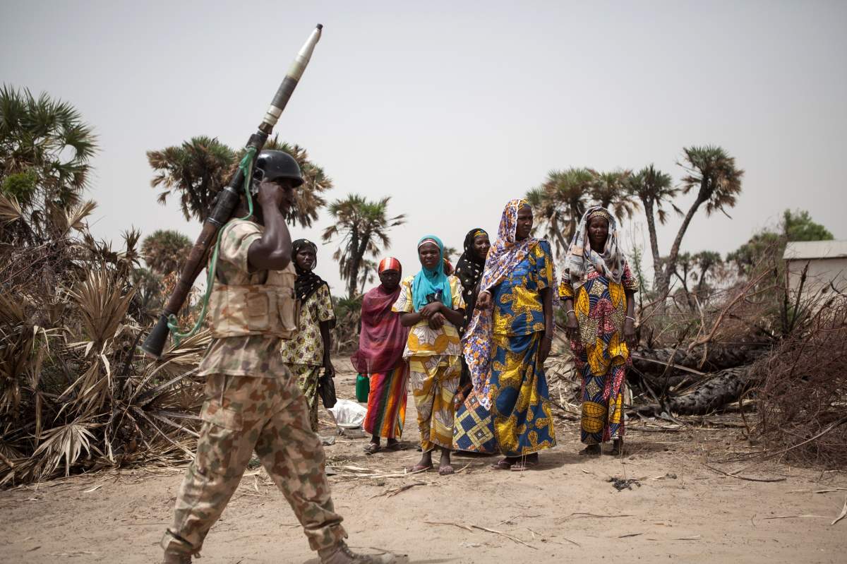 FILE -- A Nigerian soldier, with a rocket propelled grenade (RPG), patrols on the outskirt of the town of Damasak in North East Nigeria on April, 25 2017 as thousands of Nigerians, who were freed in 2016 by the Nigerian army from Boko Haram insurgents, are returning to their homes.