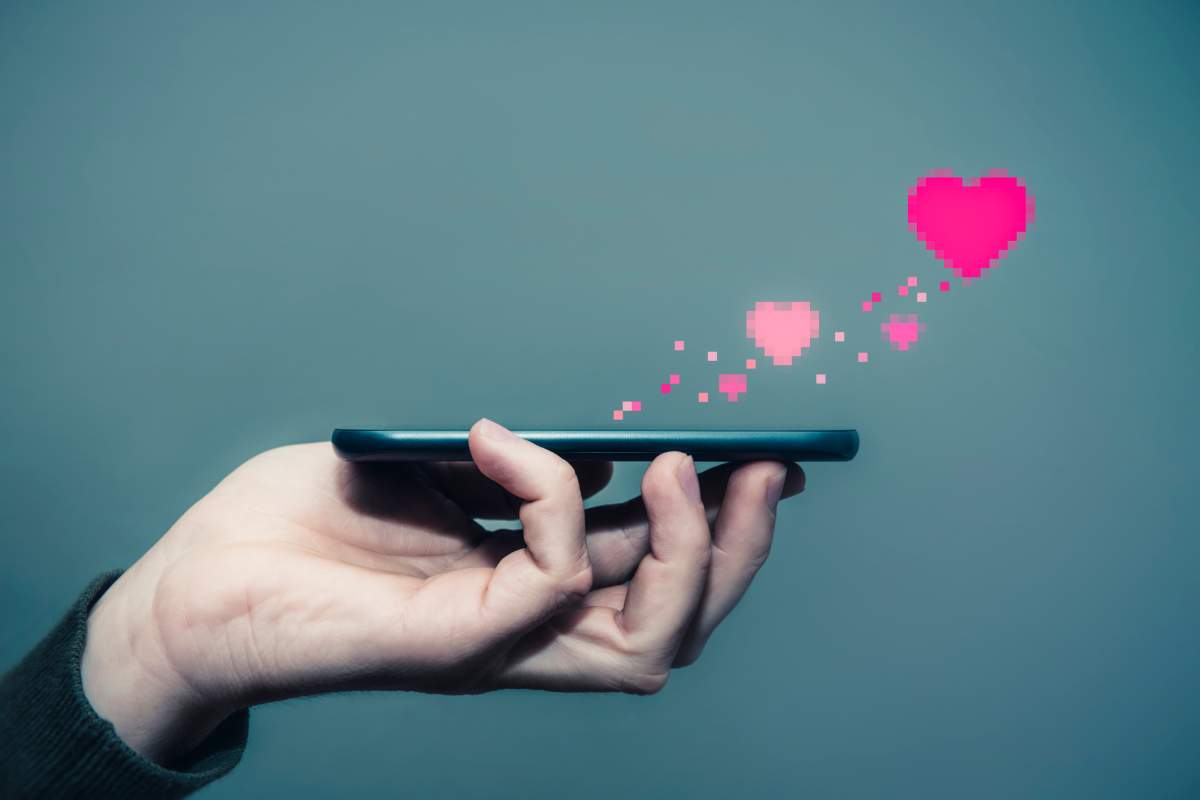 mobile in the hand of a man, send love