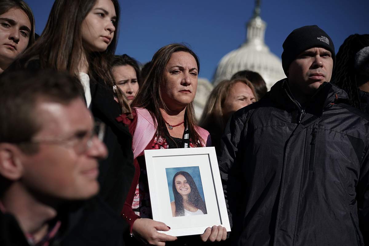 Lori Alhadeff (C) and her husband Ilan Alhadeff (R) hold a picture of their daughter Alyssa Alhadeff, a Marjory Stoneman Douglas High School shooting victim, during a news conference on gun control March 23, 2018 on Capitol Hill in Washington.