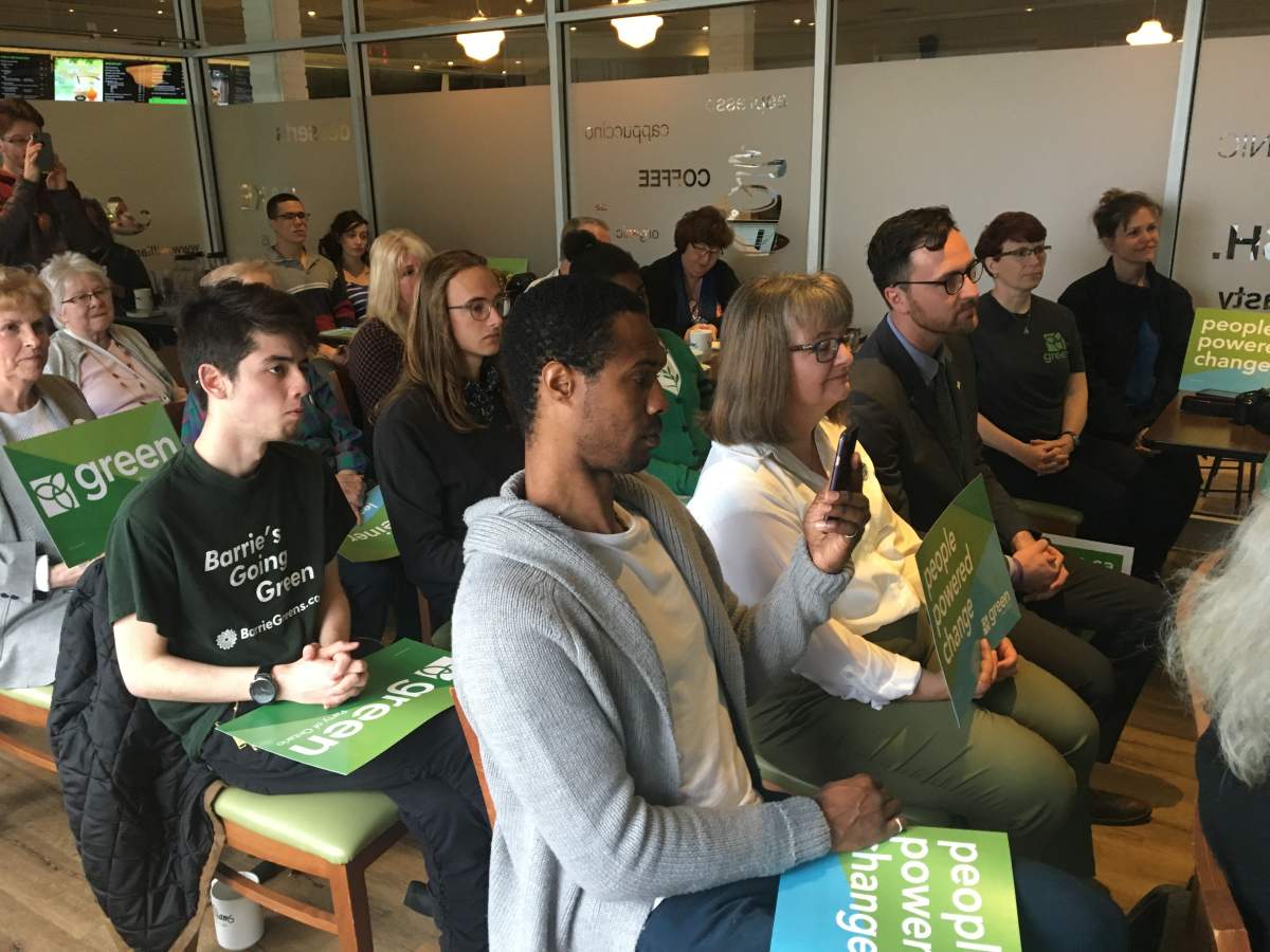 A crowd of Green Party supporters look on as Ontario Green Party leader Mike Schreiner speaks at a campaign stop in Barrie.