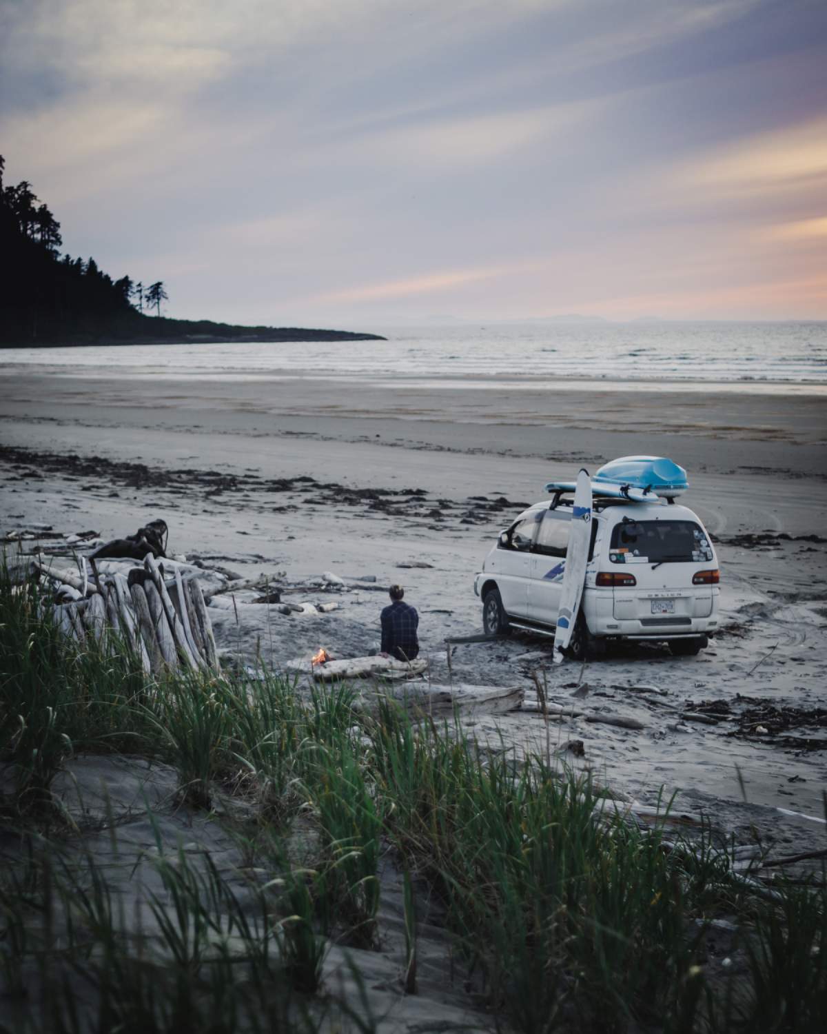 Surfer camping on North beach in Haida Gwaii.