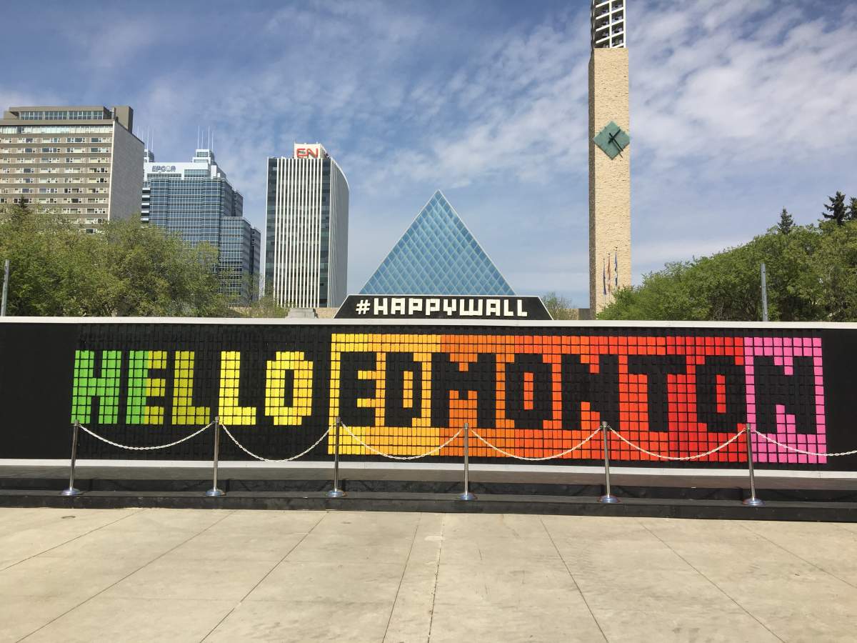 The Happy Wall is an art installation of over 1,000 wooden pixels that can be flipped to create pictures or messages. 