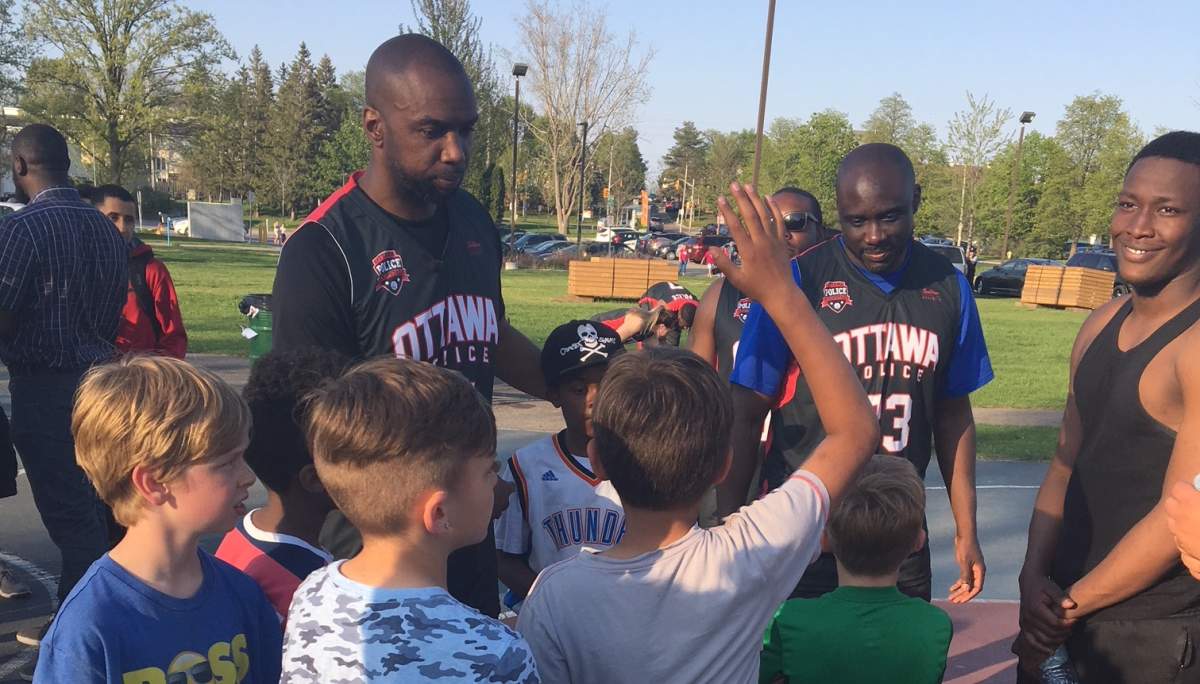 Cst. Chabine Tucker (left) and other Ottawa Police HoopStars answer questions about policing.