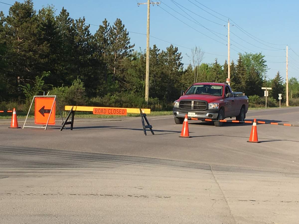 Municipal Workers with Loyalist Township block off a section of Taylor Kidd Blvd. as police investigate a fatal collision.