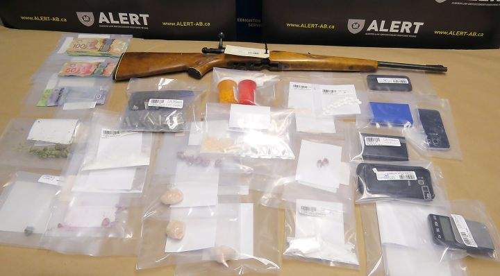 Two people have been charged after drugs, a rifle and cash were seized from a home in Lethbridge on Thursday, May 24, 2018.