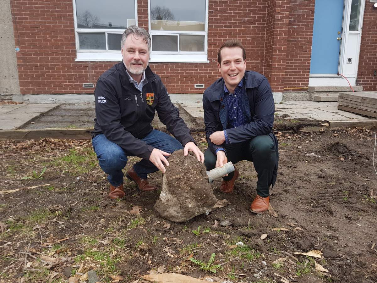 Ottawa Community Housing Chair Mathieu Fleury is pictured with Bay Ward Coun. Taylor on Thursday in front of one the Rochester Heights homes set to be demolished. 