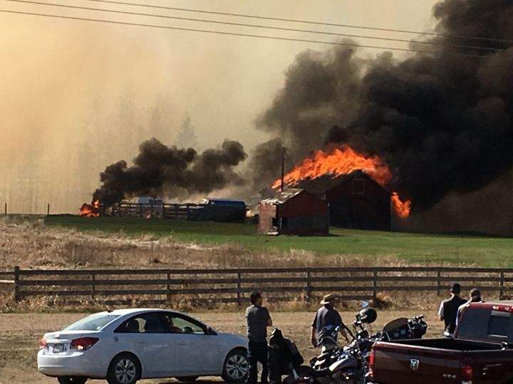 A shed on a rural property near Millet, Alta. burns Sunday evening during a grass fire.  