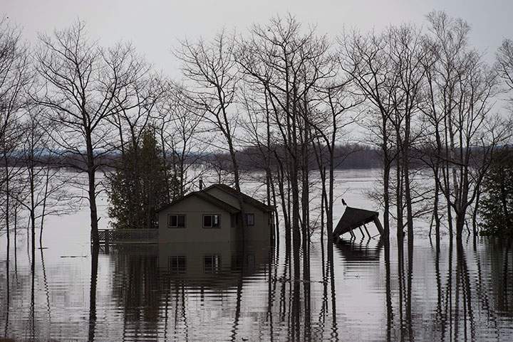 Homes and cottages are surrounded by rising floodwater from the Saint John River near Lakeville Corner, N.B. on Wednesday, May 2, 2018.