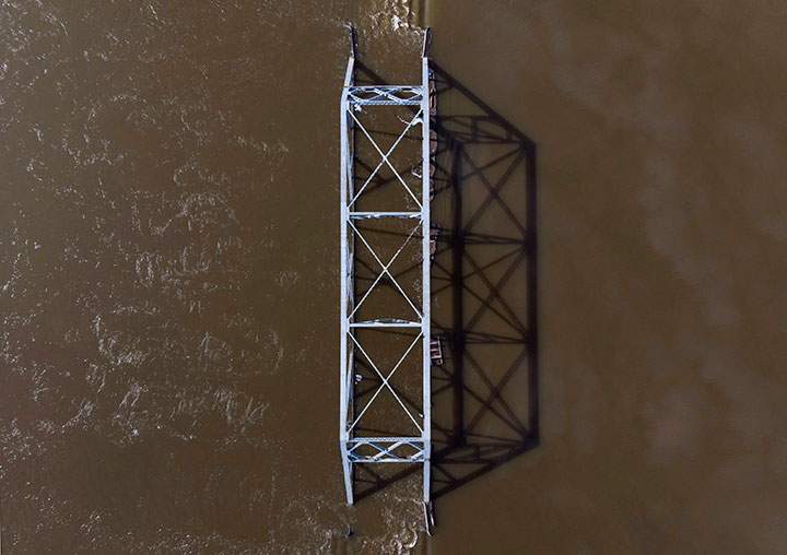 A steel bridge is engulfed by the rising floodwater from the Saint John River in Lakeville Corner, N.B. on Wednesday, May 2, 2018.