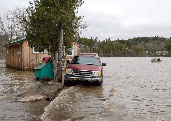 A cottage is surrounded by water from the Saint John River in Grand Bay-Westfield on Thursday, May 3, 2018.