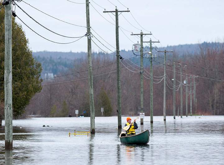 A resident paddles his canoe at Darlings Island, N.B. on Thursday, May 3, 2018.