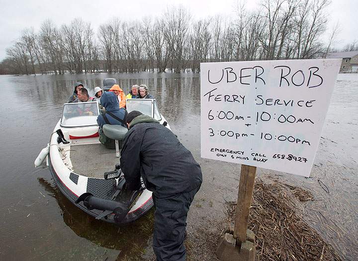 Rob Dekany, known locally as Uber Rob, ferries stranded passengers at Darlings Island, N.B. on Thursday, May 3, 2018.