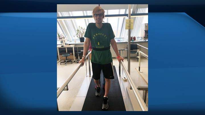 Xavier LaBelle’s mother Tanya and the Humboldt Broncos bus crash survivor taking part in his physiotherapy treatment in Saskatoon.