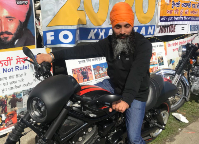 Hapreet Singh Nijjar in front of a poster calling for a 2020 referendum on the creation of a separate Sikh state called Khalistan.