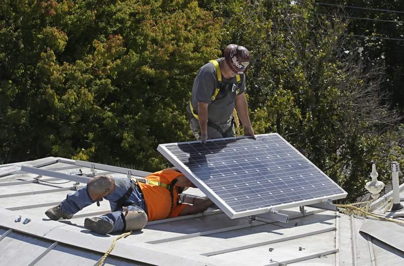 In this Oct. 16, 2015 file photo a solar panel is installed on the roof of a home.