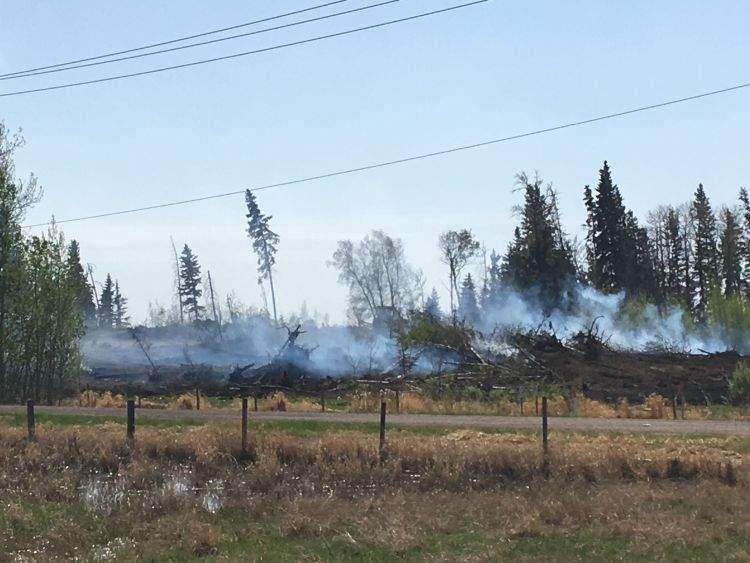 Crews continue to put out hot spots in Strathcona County on Tuesday, May 15, 2018.