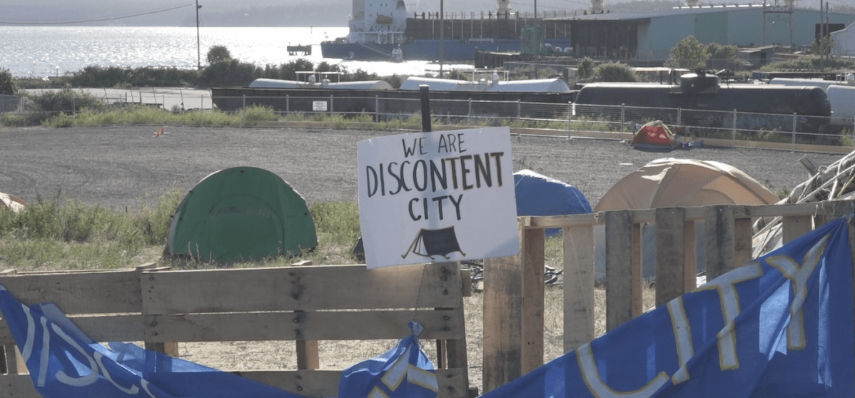 Campers who set up tents on city-owned land across from a shopping mall in downtown Nanaimo were served with eviction notices Friday.