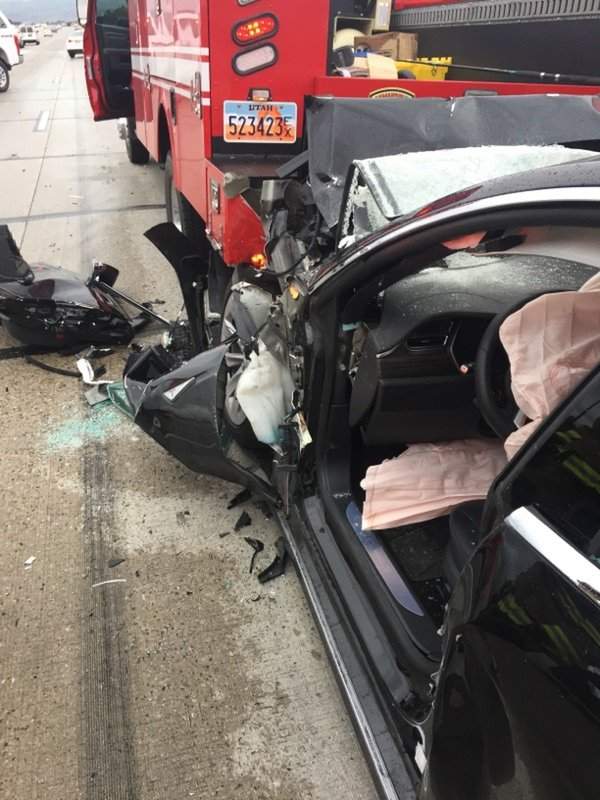 In this Friday, May 11, 2018, photo released by the South Jordan Police Department shows a traffic collision involving a Tesla Model S sedan with a Fire Department mechanic truck stopped at a red light in South Jordan, Utah.