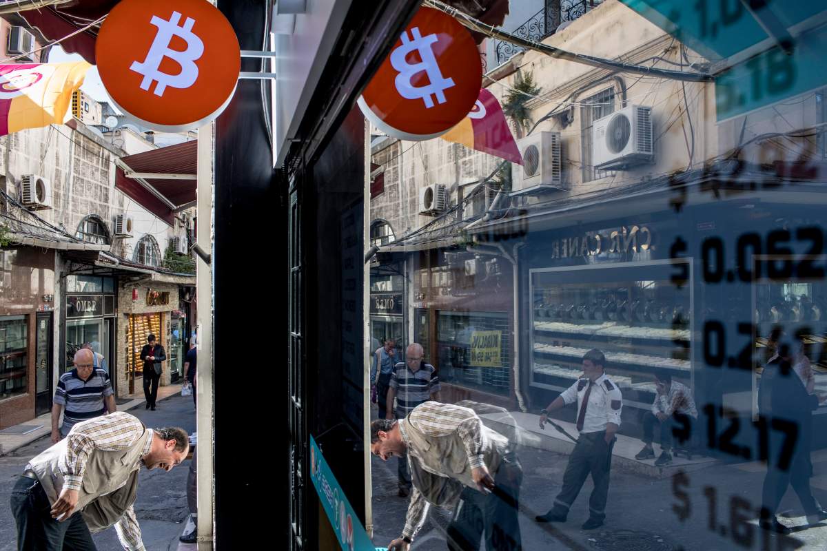 People walk in front of the first official Bitcoin exchange office in the Grand Bazaar in Istanbul, Turkey, 30 May 2018.