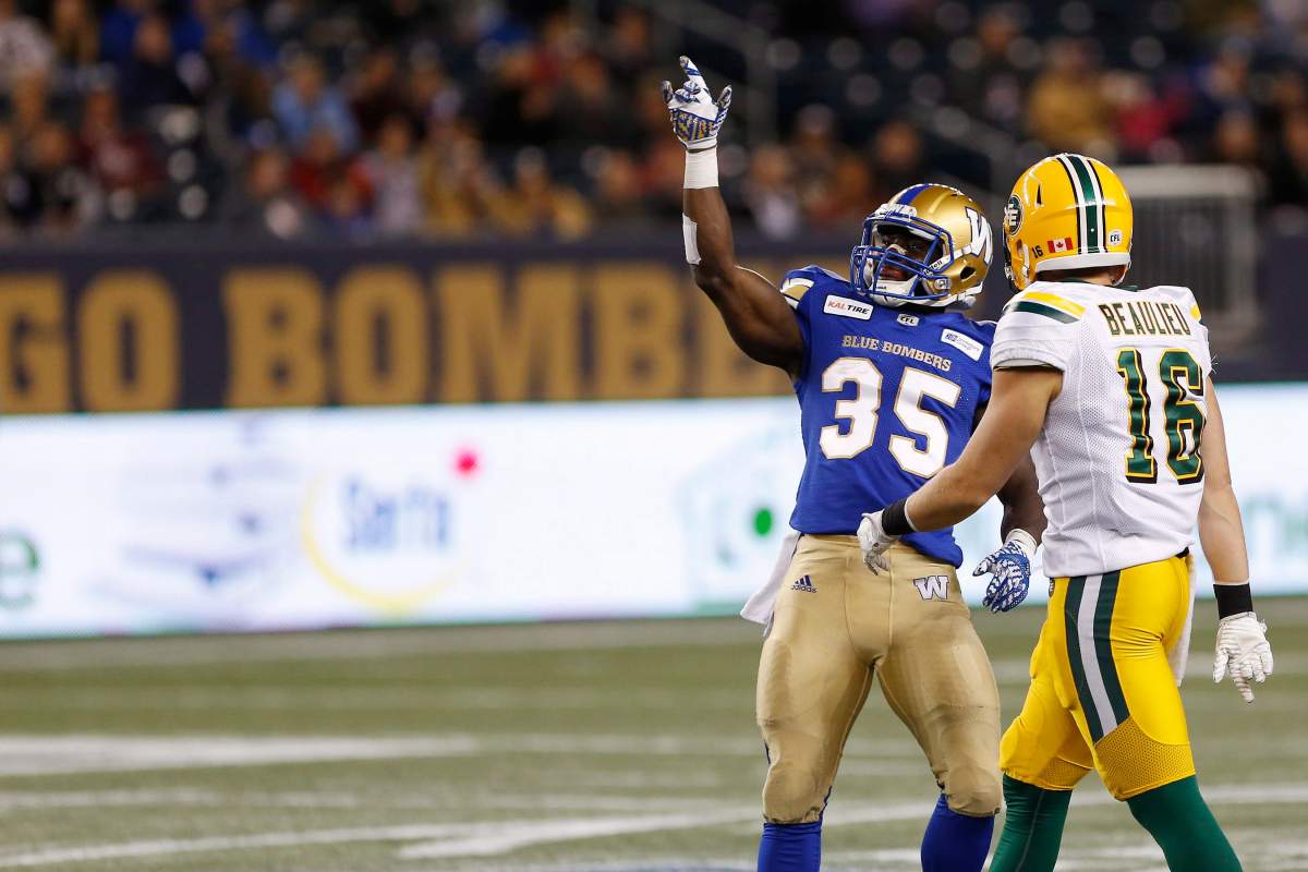 Winnipeg Blue Bombers’ wb35 celebrates his first down run as Edmonton Eskimos’ Jordan Beaulieu (16) looks on during the second half of pre-season CFL action in Winnipeg Friday, June 1, 2018.