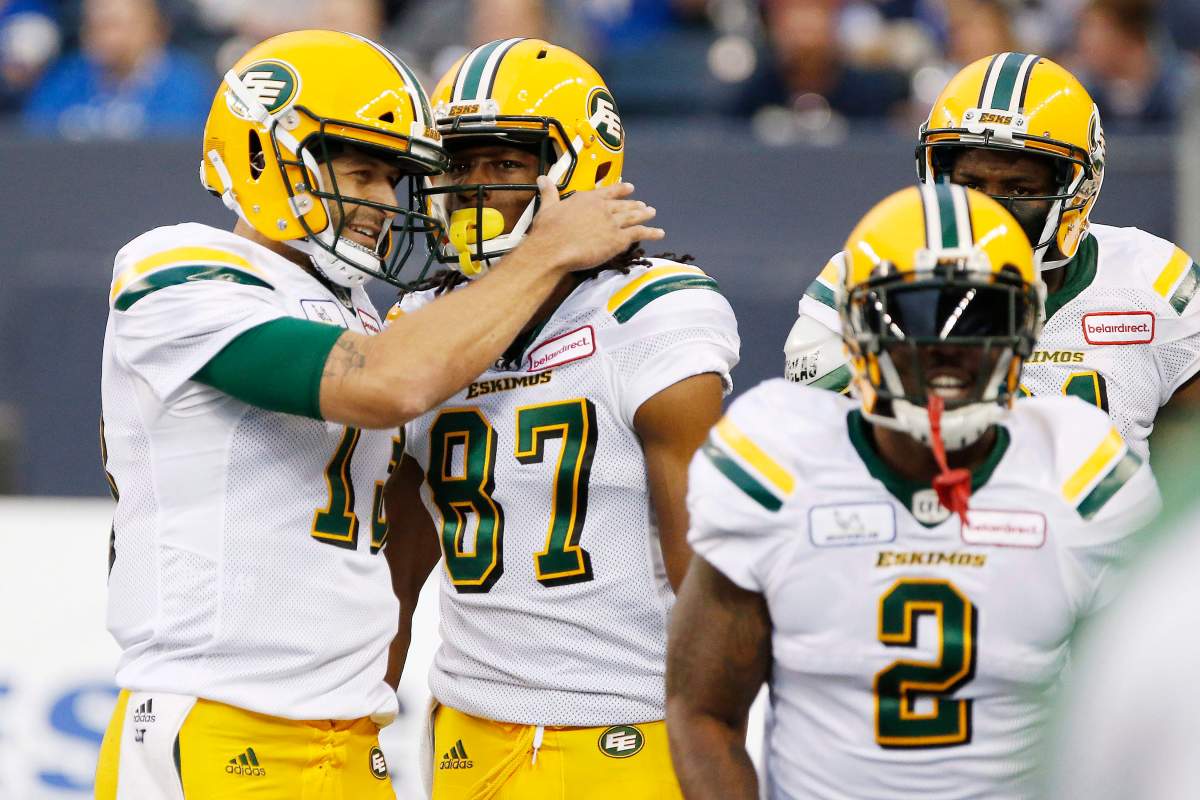 Edmonton Eskimos quarterback Mike Reilly (13) and Derel Walker (87) celebrate Walkers' touchdown against the Winnipeg Blue Bombers during the first half of CFL action in Winnipeg Thursday, June 14, 2018.