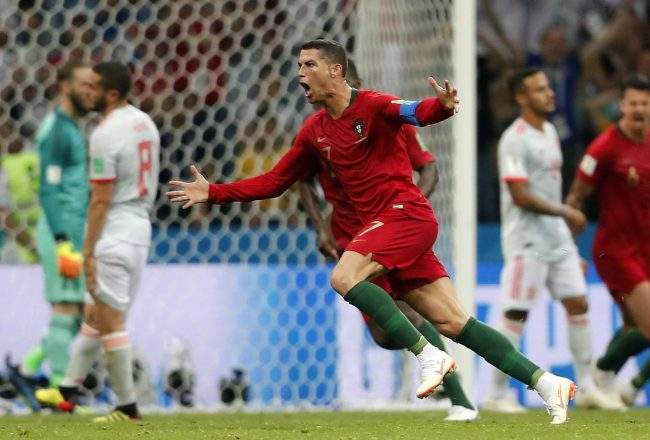 Portugal's Cristiano Ronaldo celebrates after scoring his third goal with a free kick during the Group B match between Portugal and Spain in FIFA World Cup action at the Fisht Stadium in Sochi, Russia, June 15, 2018.