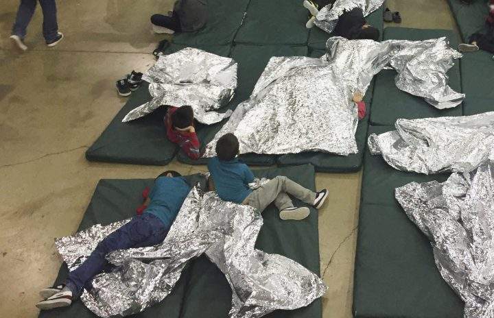 In this photo provided by U.S. Customs and Border Protection, people who've been taken into custody related to cases of illegal entry into the United States, rest in one of the cages at a facility in McAllen, Texas, Sunday, June 17, 2018. 
