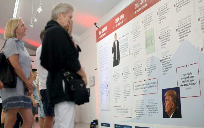 Visitors look at tweets at The Donald J. Trump Presidential Twitter Library presented by The Daily Show in West Hollywood, California, U.S., June 8, 2018.