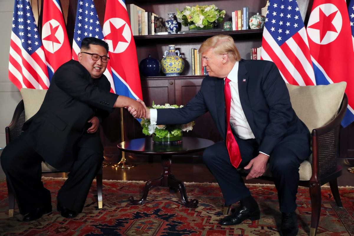 U.S. President Donald Trump shakes hands with North Korea’s leader Kim Jong Un before their bilateral meeting at the Capella Hotel on Sentosa island in Singapore June 12, 2018.