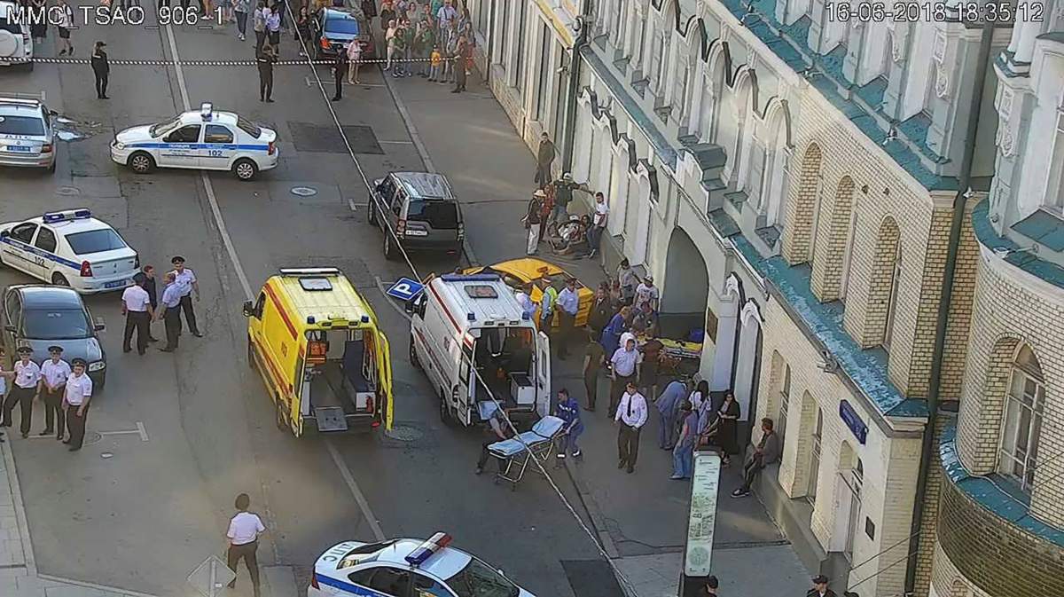 Police officers, investigators and members of emergency services work at the site of an accident after a taxi ran into a crowd of people in central Moscow, Russia June 16, 2018.