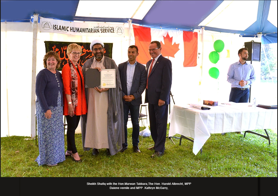 The director of the Islamic Humanitarian Organization, who called for Israeli soldiers in Gaza to be sent home in “body bags,” is seen at centre with Liberal MP Marwan Tabbara and Conservative MP Harold Albrecht at his right.
