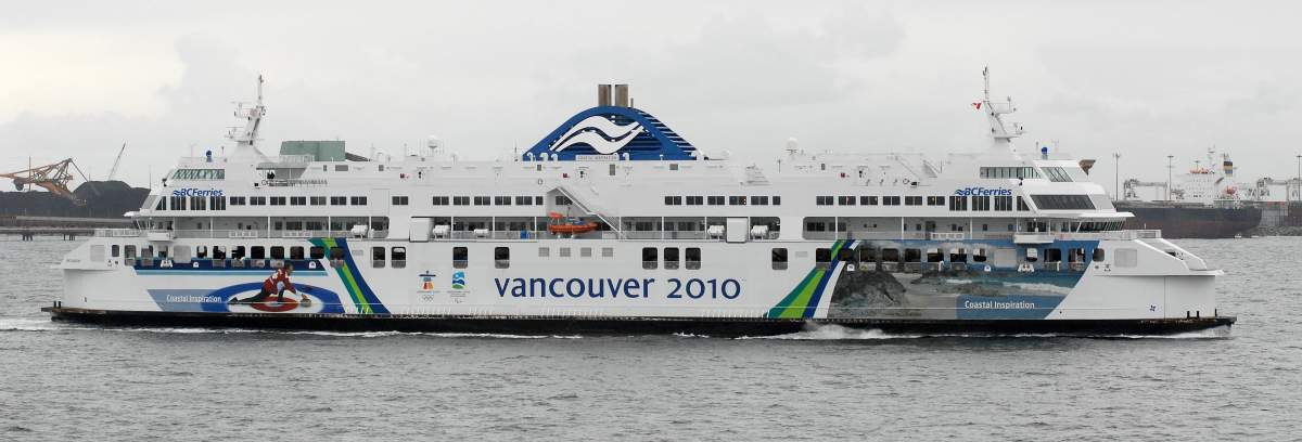 The BC Ferries vessel Coastal Inspiration heads into the Tsawwassen Ferry Terminal (not seen) on a cloudy day. 