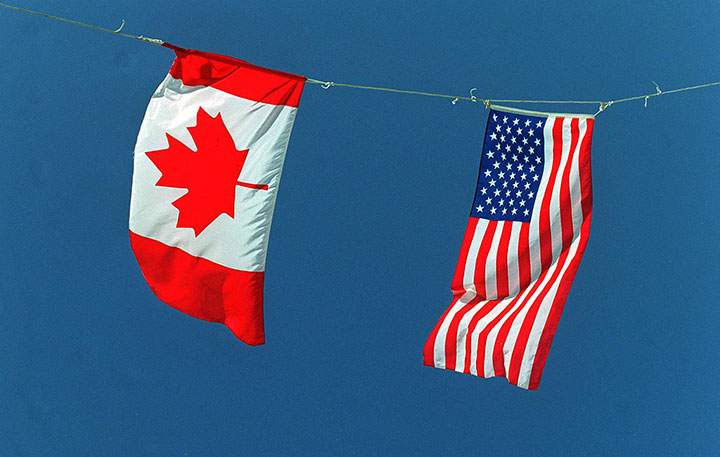 A Canadian and American flag are pictured in this undated file photo.