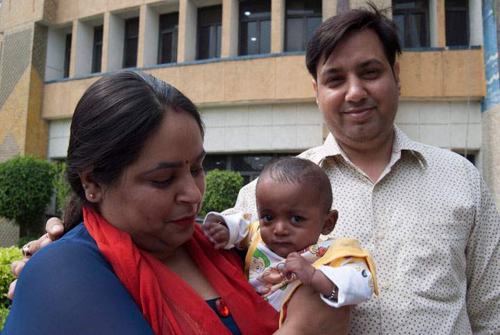 Mother Anu Bhalla and father Pawan Bhalla pose with their baby Naksh Bhalla in India on April 11, 2018. The baby is the surviving one of two twins born prematurely. He successfully fought off a drug-resistant infection.