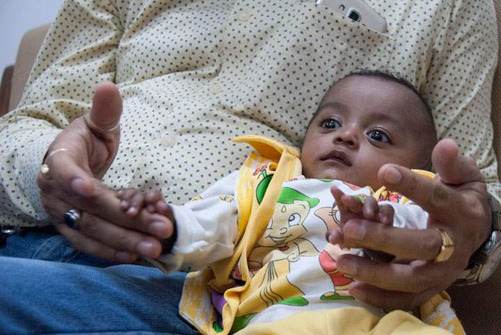 Naksh Bhalla sits up in his father’s arms. The baby survived a drug-resistant infection after being treated with colistin, a last-resort antibiotic.