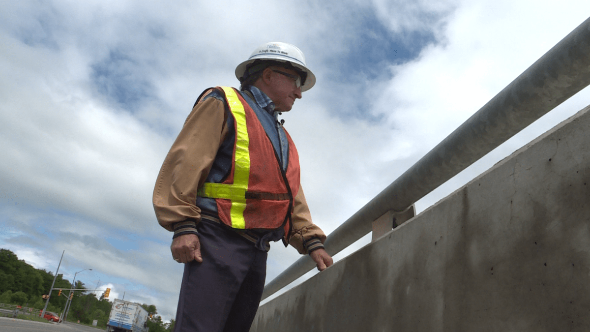 Owner of Corcoran Excavating, Dan Corcoran looks toward a 401 construction site from the Montreal Street overpass.