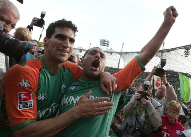 Canadian Paul Stalteri, left, and Brazilian teammate Ailton celebrate winning the German Bundesliga championship in Munich, Germany, May 8, 2004.
