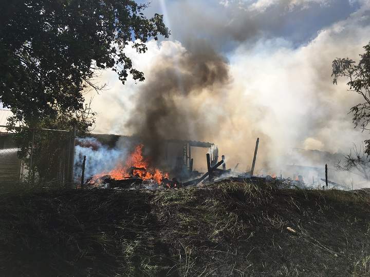 Fire ravaged two houses on Wednesday in Grand Forks. Though the houses were destroyed, all occupants made it out safely.