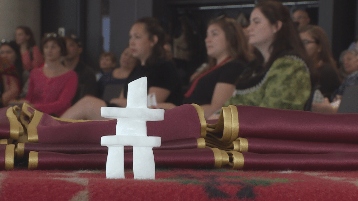 Students did not receive their diplomas but instead were bestowed a red and gold stole which features a white feather.