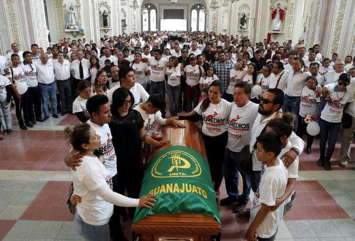 Friends and relatives pay their last respects to Jose Remedios Aguirre, a mayoral candidate who was shot in broad daylight two days prior, during his funeral Mass in Apaseo El Alto, Mexico, Sunday, May 13, 2018. 