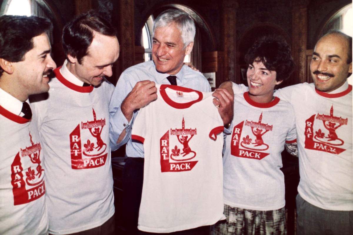 The Liberal Party’s “Rat Pack,” joke with Opposition Leader John Turner after giving him a Rat Pack T-shirt in his Parliament Hill office Wednesday, May 8, 1985. The four Liberal backbench MPs, (from left) Brian Tobin, Don Boudria, Sheila Copps and John Nunziata, have made themselves stand out in the House of Commons with their attacks on the government and their highly vocal presence. (CP PHOTO/stf-Ron Poling)