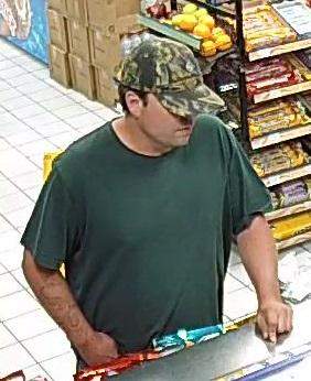 Police are looking to identify a suspect (above) accused of robbing a convenience store in Barrie.